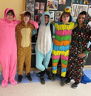 Students in pajamas in the hallway